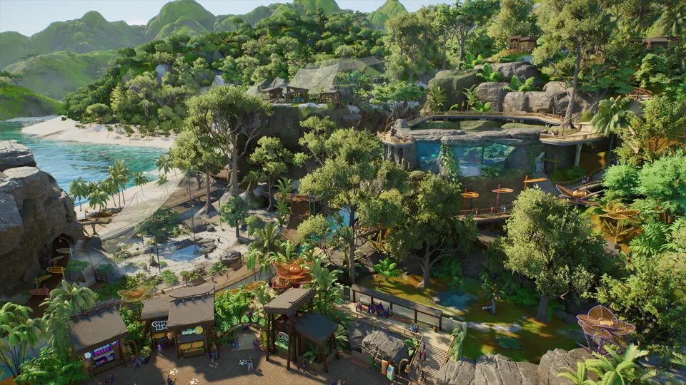 Aerial view of a tropical island zoo with a beach and an aquarium in Planet Zoo 2