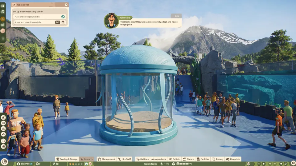 A jellyfish exhibit dome with zoo guests and a mission objective panel in Planet Zoo 2